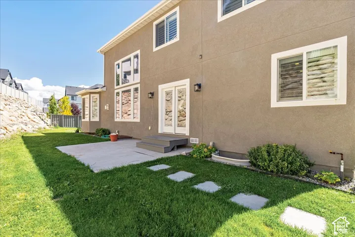 Stucco exterior with multiple windows, bay window, and double glass doors