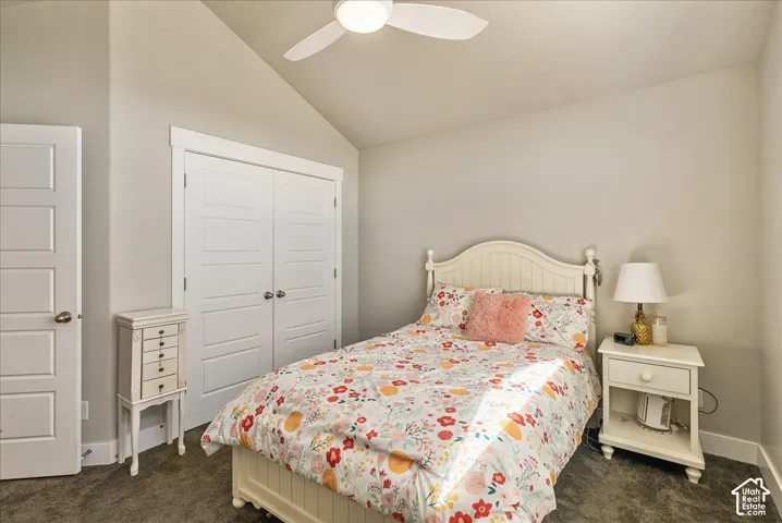Angled ceiling, ceiling fan, carpet flooring, white paneled doors