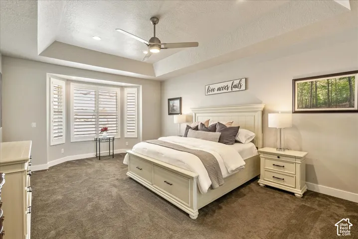 Main Floor Primary Suite-Tray ceiling with recessed lighting and ceiling fan