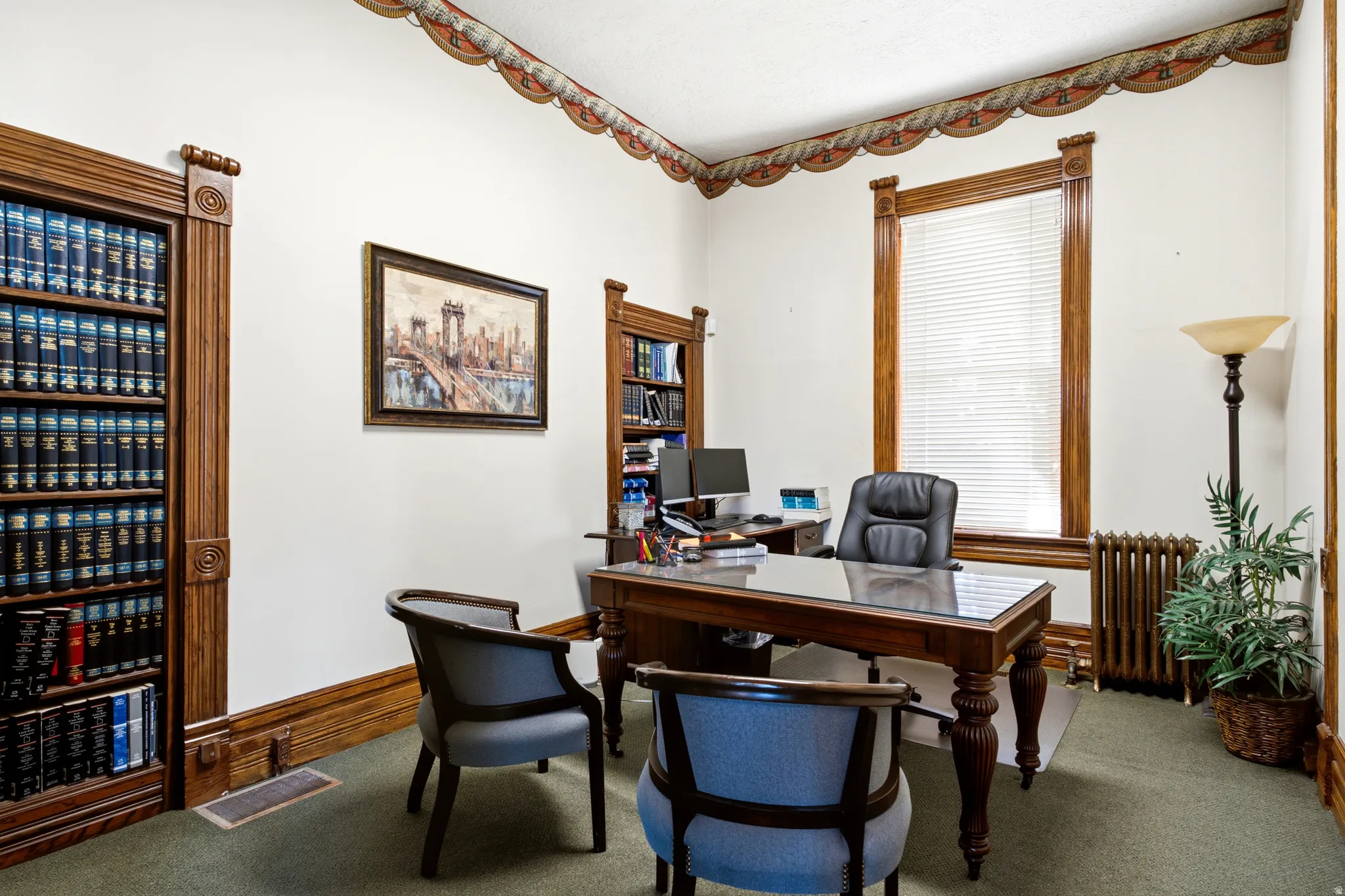 Built-in wooden shelving, ornate crown molding, and wood-trimmed window