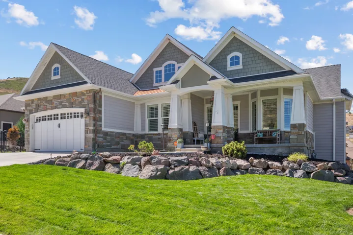 Stone and siding exterior with a multi-gabled roofline