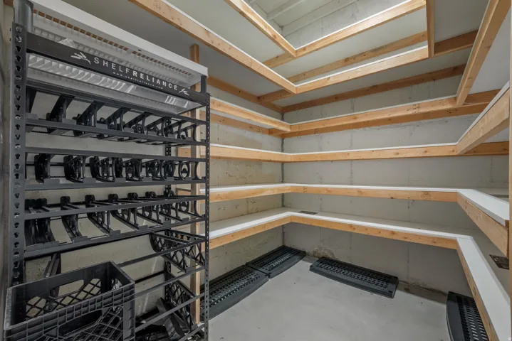 Concrete basement walls with extensive built-in wooden shelving