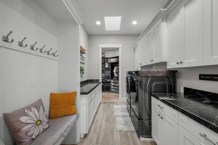 Mudroom with built-in bench seating and wall hooks