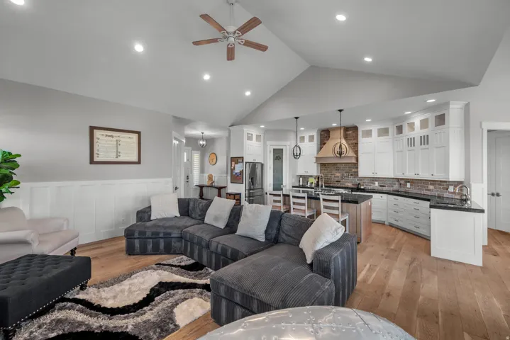 Vaulted ceiling with recessed lighting and a ceiling fan
