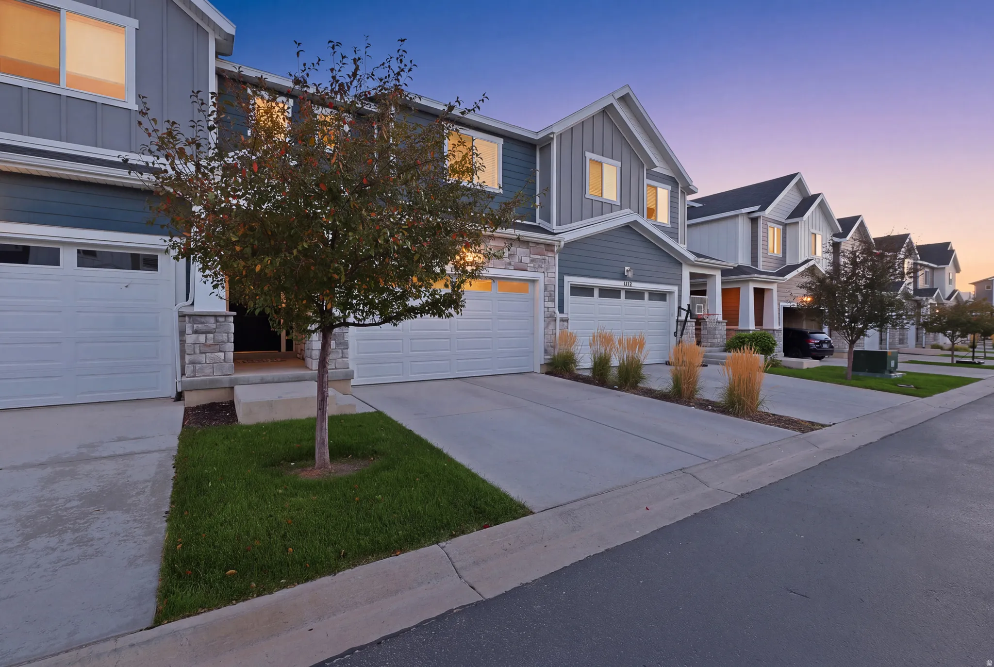 Contemporary exterior featuring horizontal siding, stone accents, and an attached two-car garage