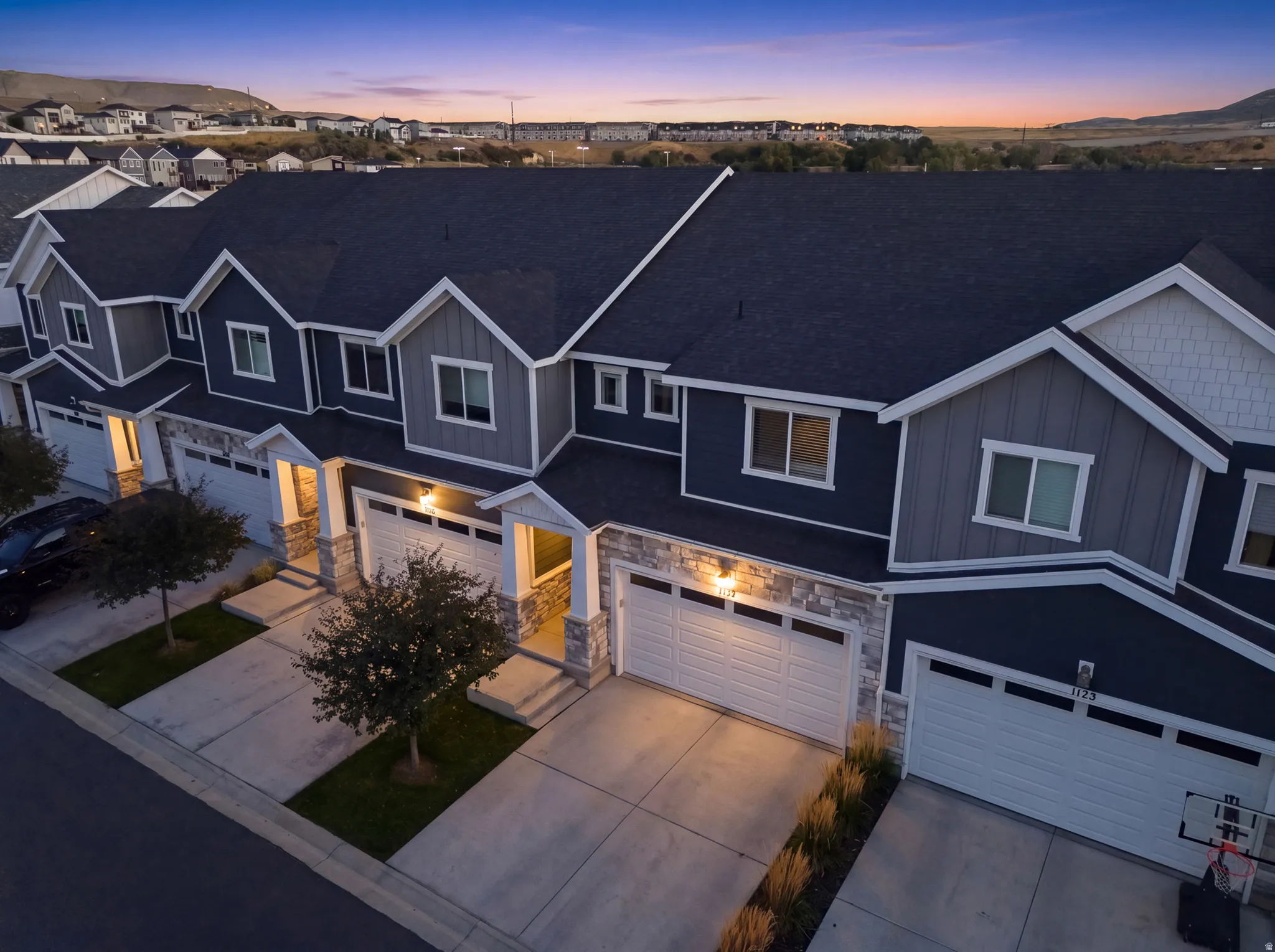 Modern townhome exterior with dark siding and white trim