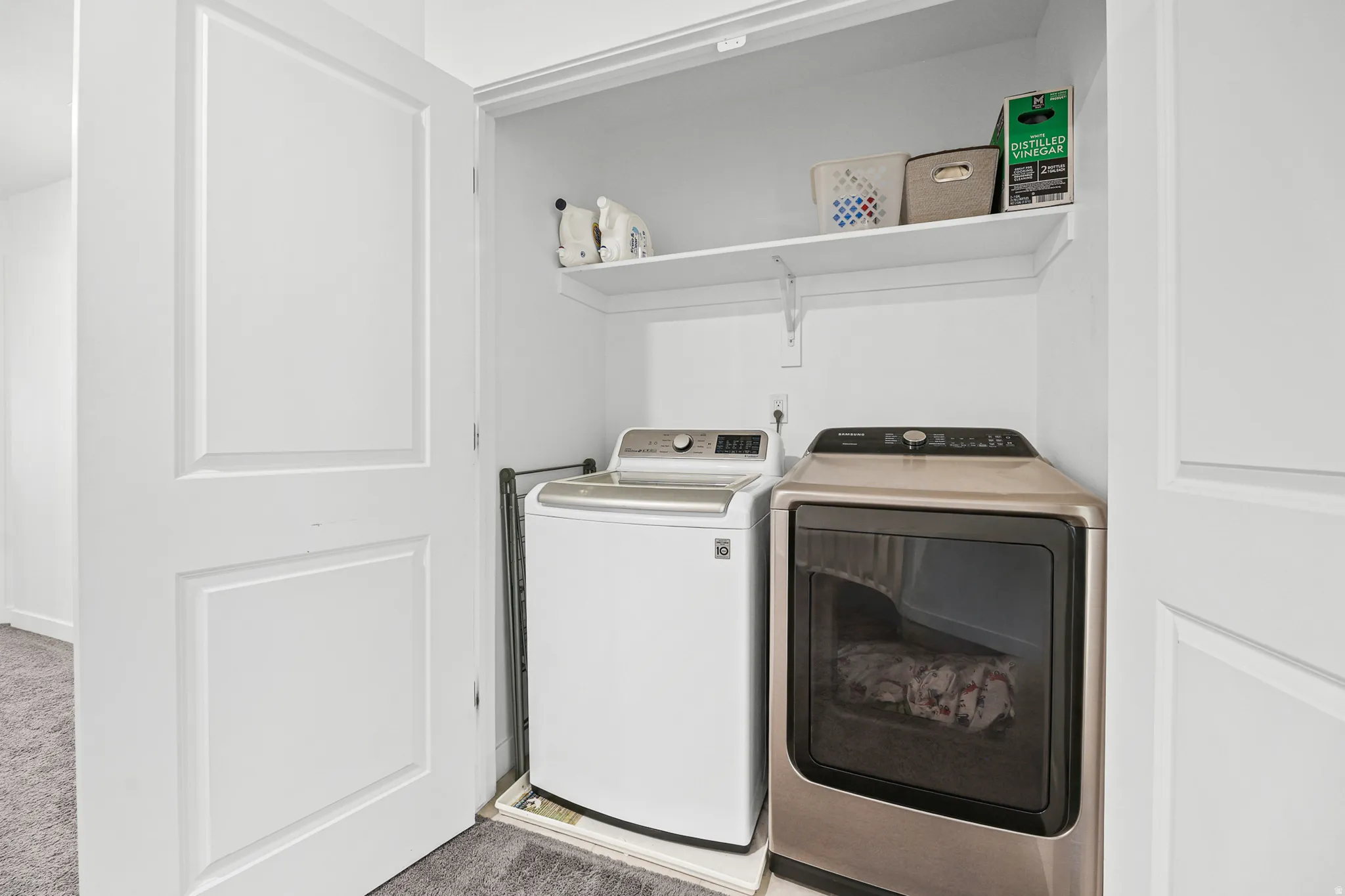 Dedicated laundry closet with built-in shelving