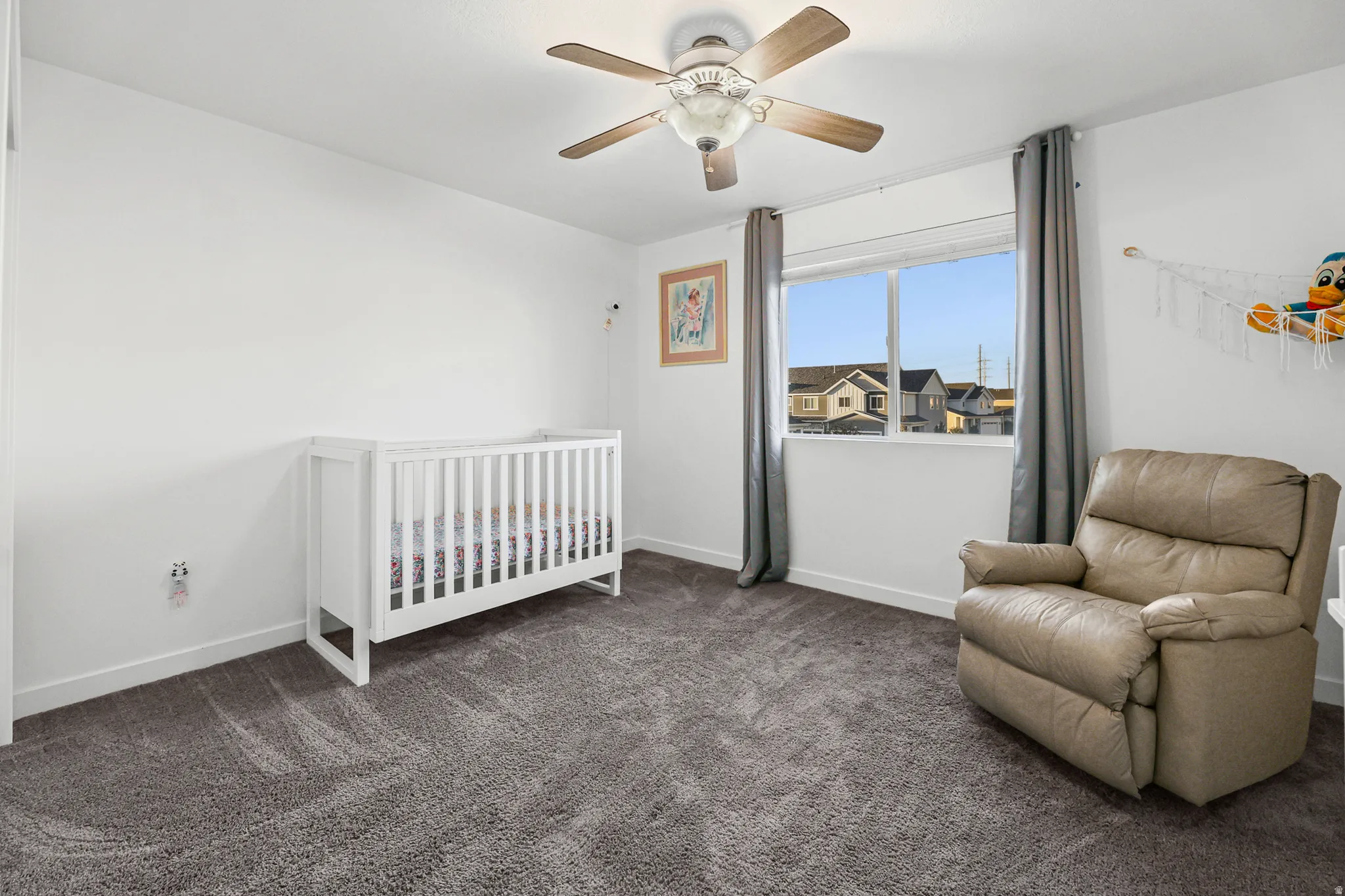 Light gray wall-to-wall carpeting with white baseboards and trim