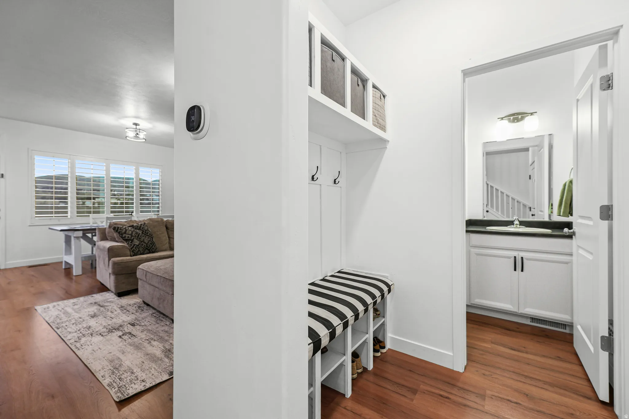 Built-in entryway storage bench with hooks and upper shelving