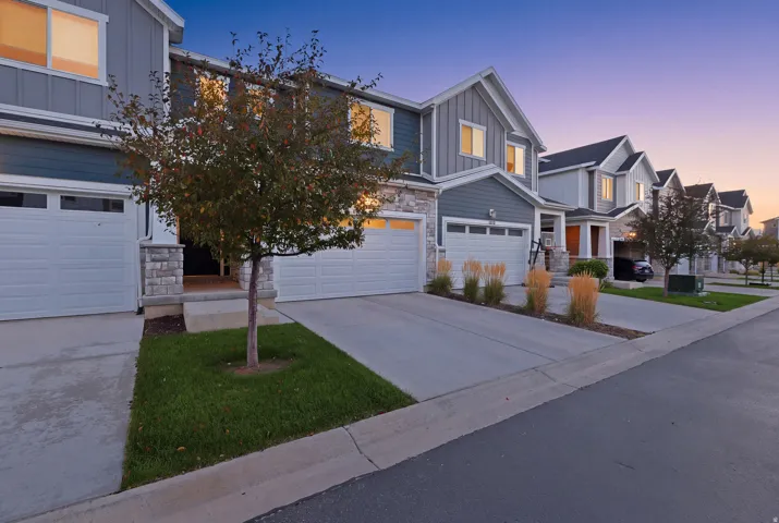 Contemporary exterior featuring horizontal siding, stone accents, and an attached two-car garage