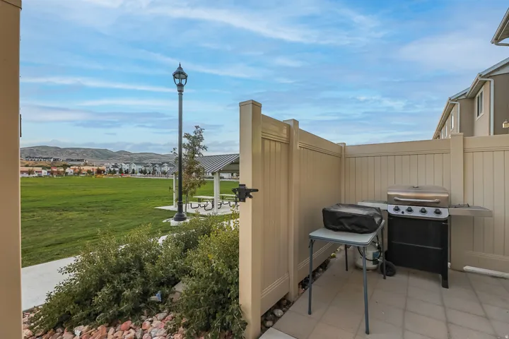 Private patio with tiled flooring and a high privacy fence