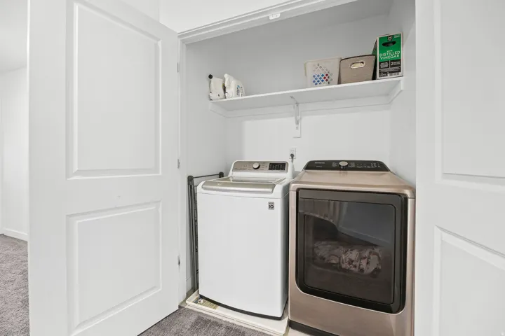 Dedicated laundry closet with built-in shelving
