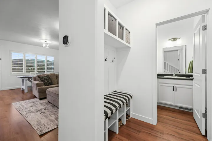Built-in entryway storage bench with hooks and upper shelving