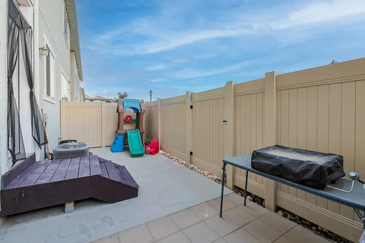 Paved patio area with a privacy fence
