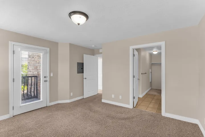 Neutral paint finishes throughout, carpeted flooring, and a flush-mount ceiling light fixture
