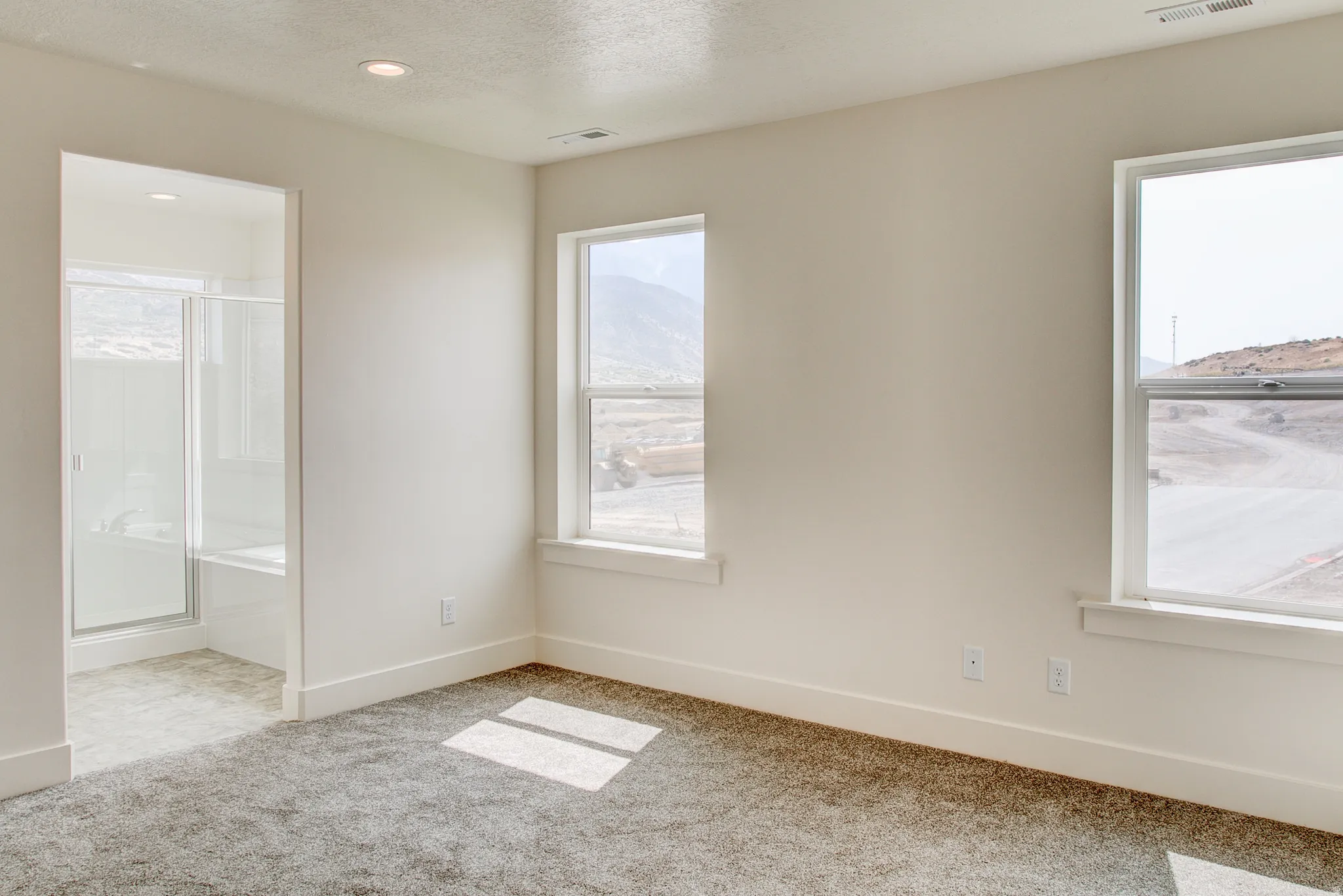 Neutral-toned walls with recessed lighting