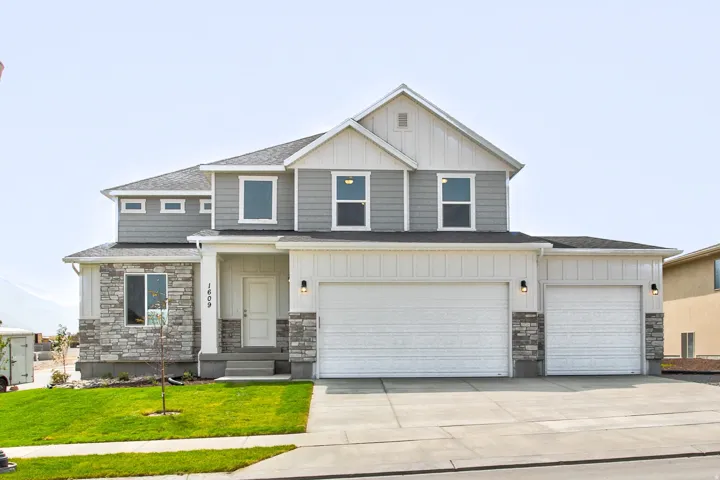 Two-story exterior with a mixed material facade, featuring stone and siding