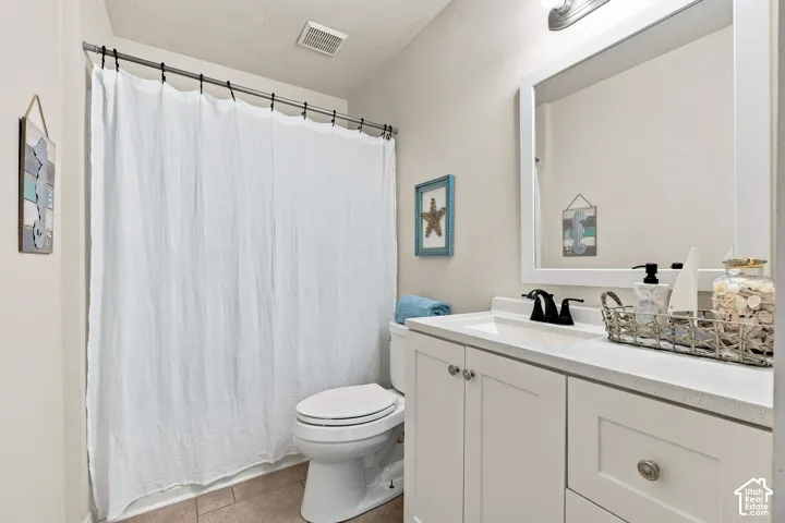 White vanity with a solid surface countertop and undermount sink