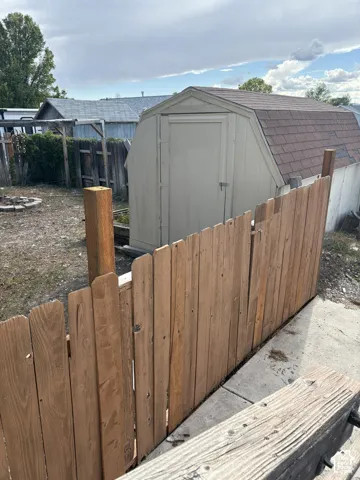 Fenced yard, with large shed