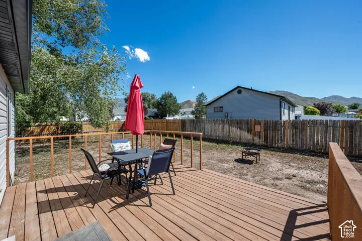 Expansive wood deck with a perimeter railing and a large fenced backyard