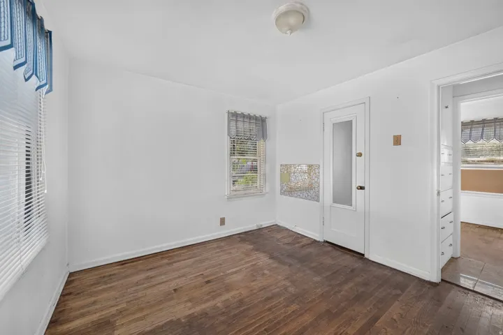 Wood-finish flooring with white walls and trim