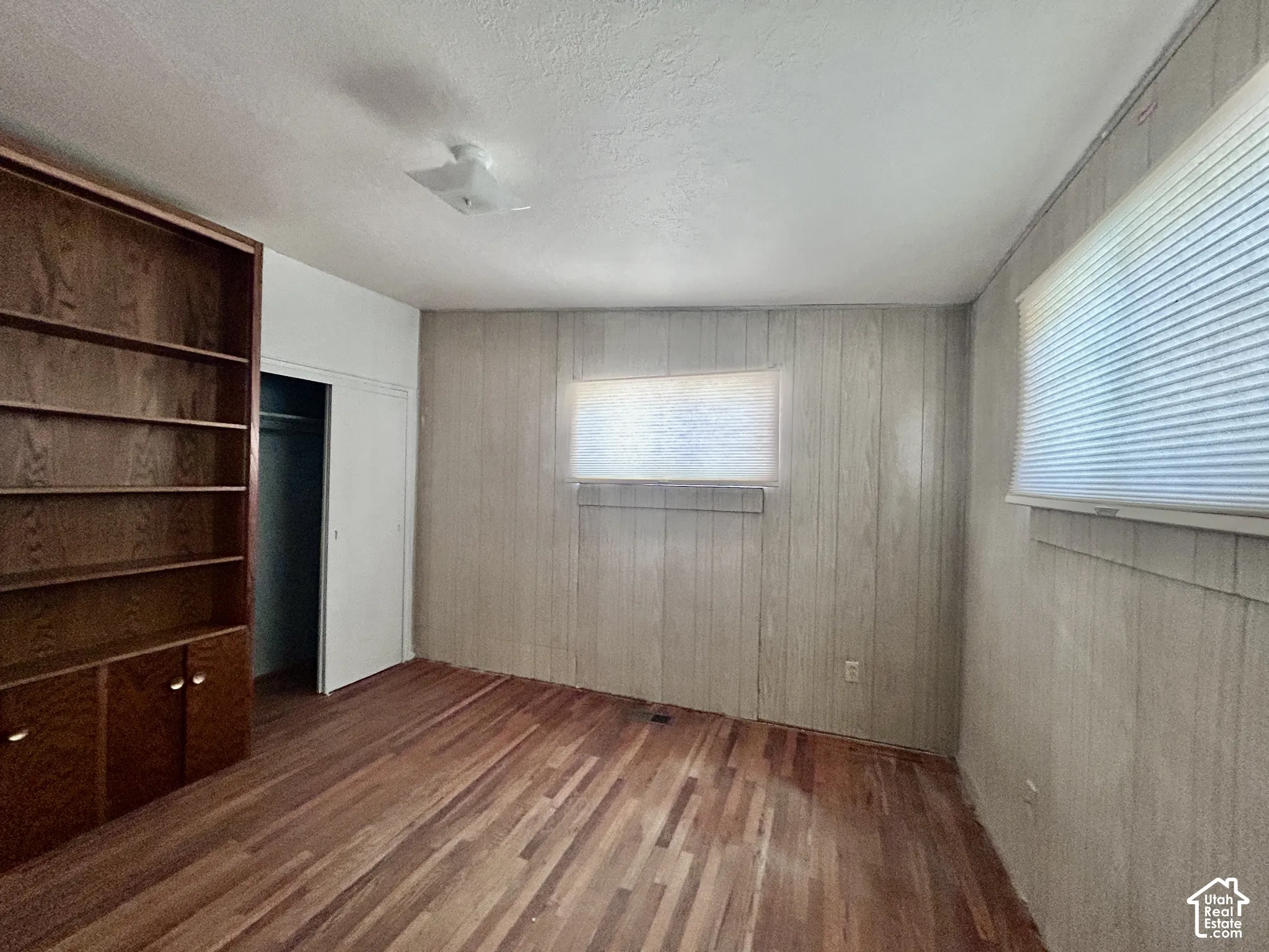 Bedroom #1 on the main floor with a large bookcase that is included