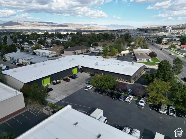 Expansive commercial property featuring multiple buildings with dark siding and light-colored roofing