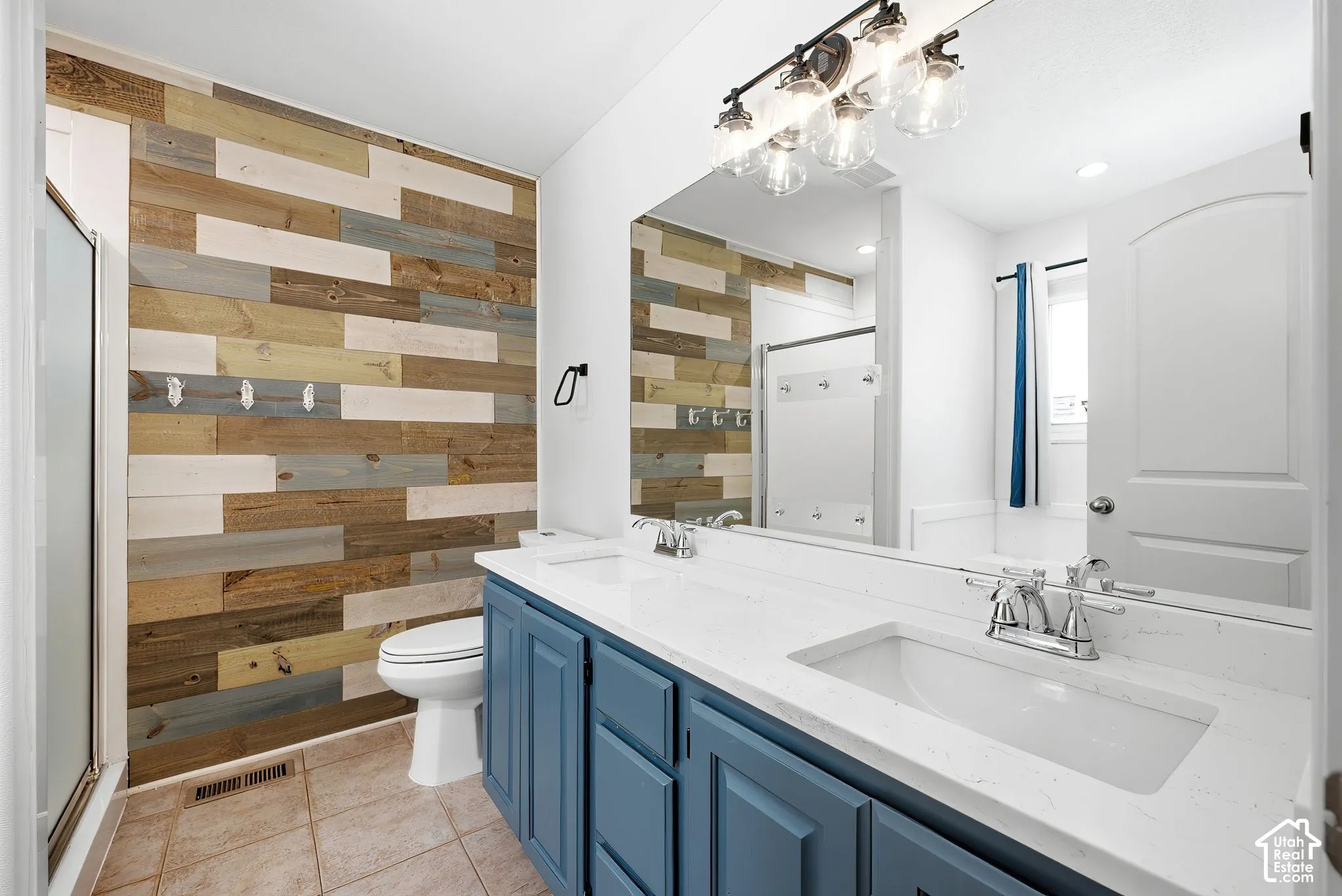 Dual vanity with undermount sinks and blue cabinetry