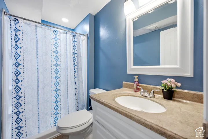Vanity with a built-in sink, framed mirror, and integrated lighting fixture
