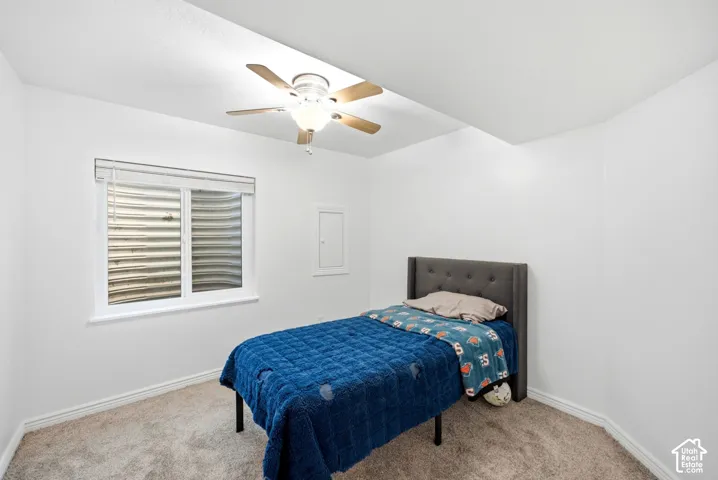 Recessed window with white trim, wall-to-wall carpeting, and a ceiling fan with integrated lighting