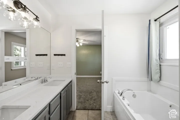 Double vanity with integrated sinks, white countertop, and brushed nickel faucets