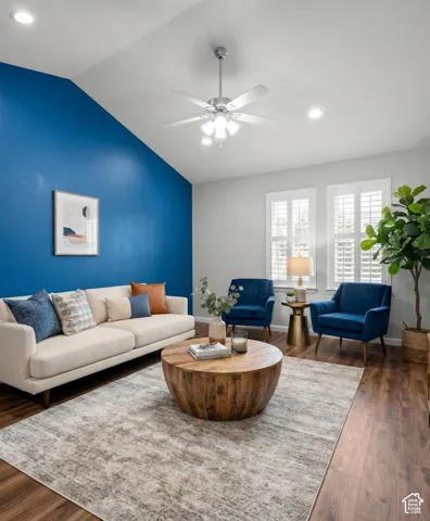 Vaulted ceiling with a ceiling fan, recessed lighting, wood-finish flooring, and two windows with plantation shuttersvirtual staging