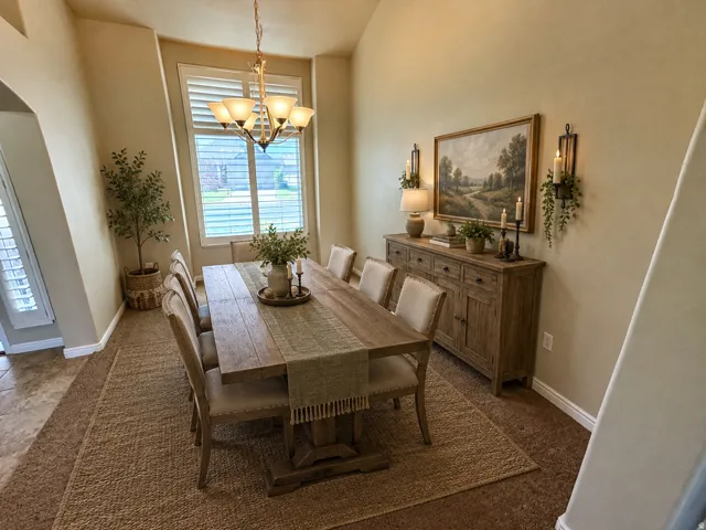 Formal sitting room or formal dinning room with vaulted ceilings that accentuate the spacious room with extra tall windows.