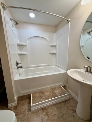 Bathroom 3, White tub and shower combination with integrated shelving