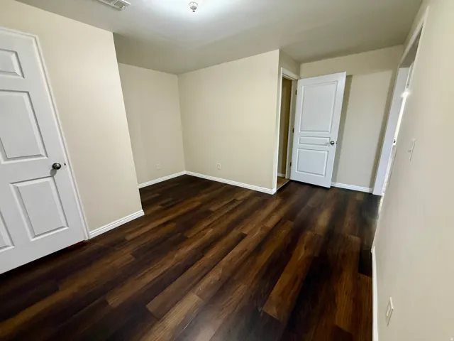 Wood-finish LVP flooring with neutral wall tones and white trim