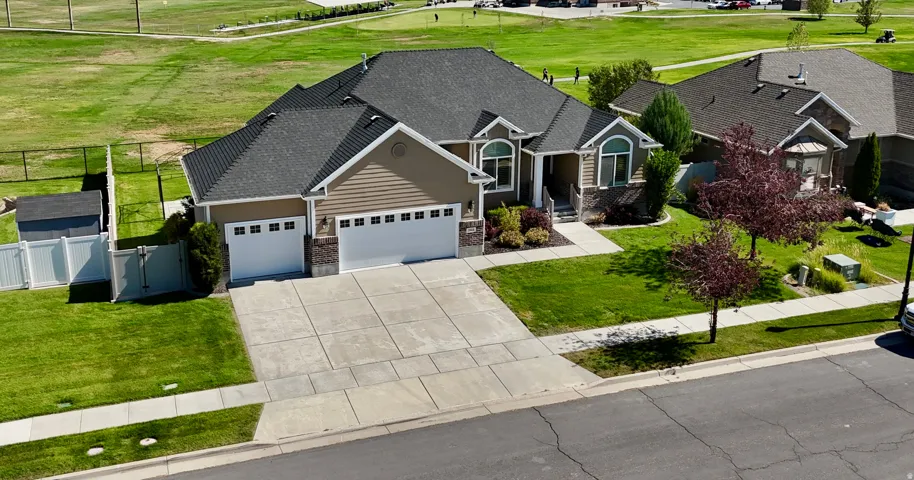 Stone and siding exterior with a dark shingle roof