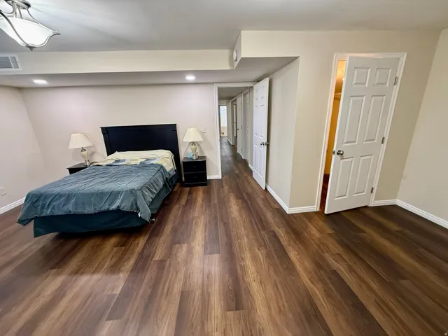Bedroom 4, Wood-finish LVP flooring throughout, recessed lighting, white trim and walk in closet.