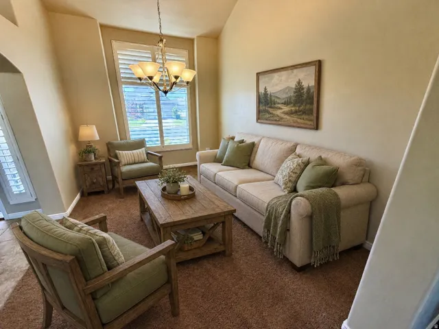 Formal sitting room or formal dinning room with vaulted ceilings that accentuate the spacious room with extra tall windows.