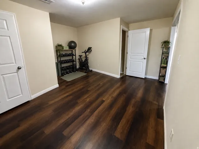 Wood-finish LVP flooring throughout, neutral wall tones, and white trim