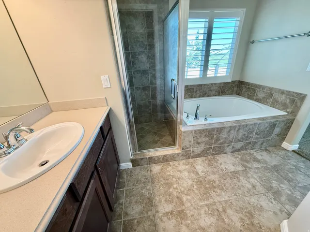 Master Bathroom Built-in bathtub with tiled surround, glass-enclosed shower