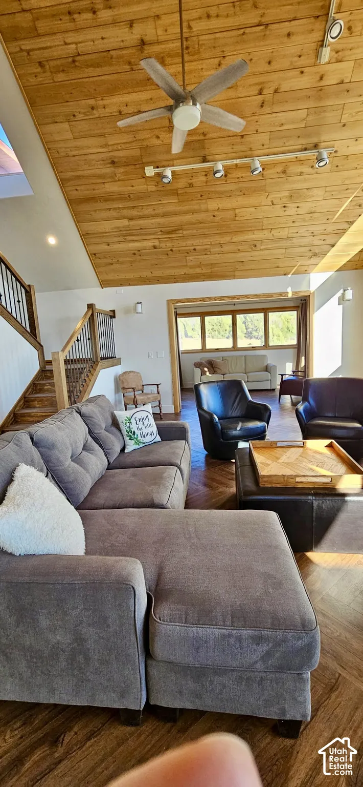 Vaulted wood-paneled ceiling with a ceiling fan, recessed lighting, and track lighting