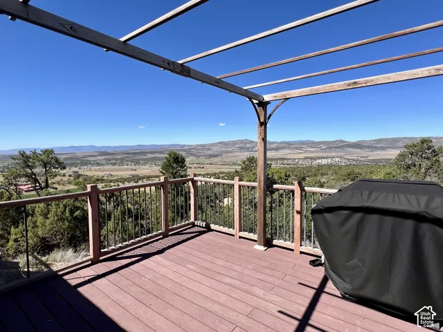 Expansive composite deck with a wood structure, offering distant mountain and valley scenery