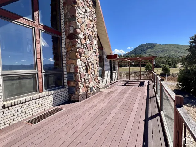 Expansive outdoor deck with composite decking and glass panel railings