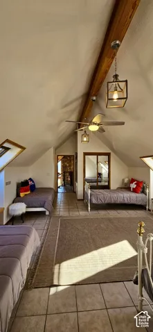 Vaulted ceilings with exposed wood beams, tile flooring, and integrated skylight windows