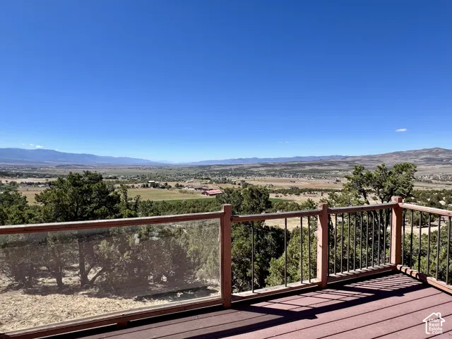 Expansive outdoor deck with composite decking and glass panel railing