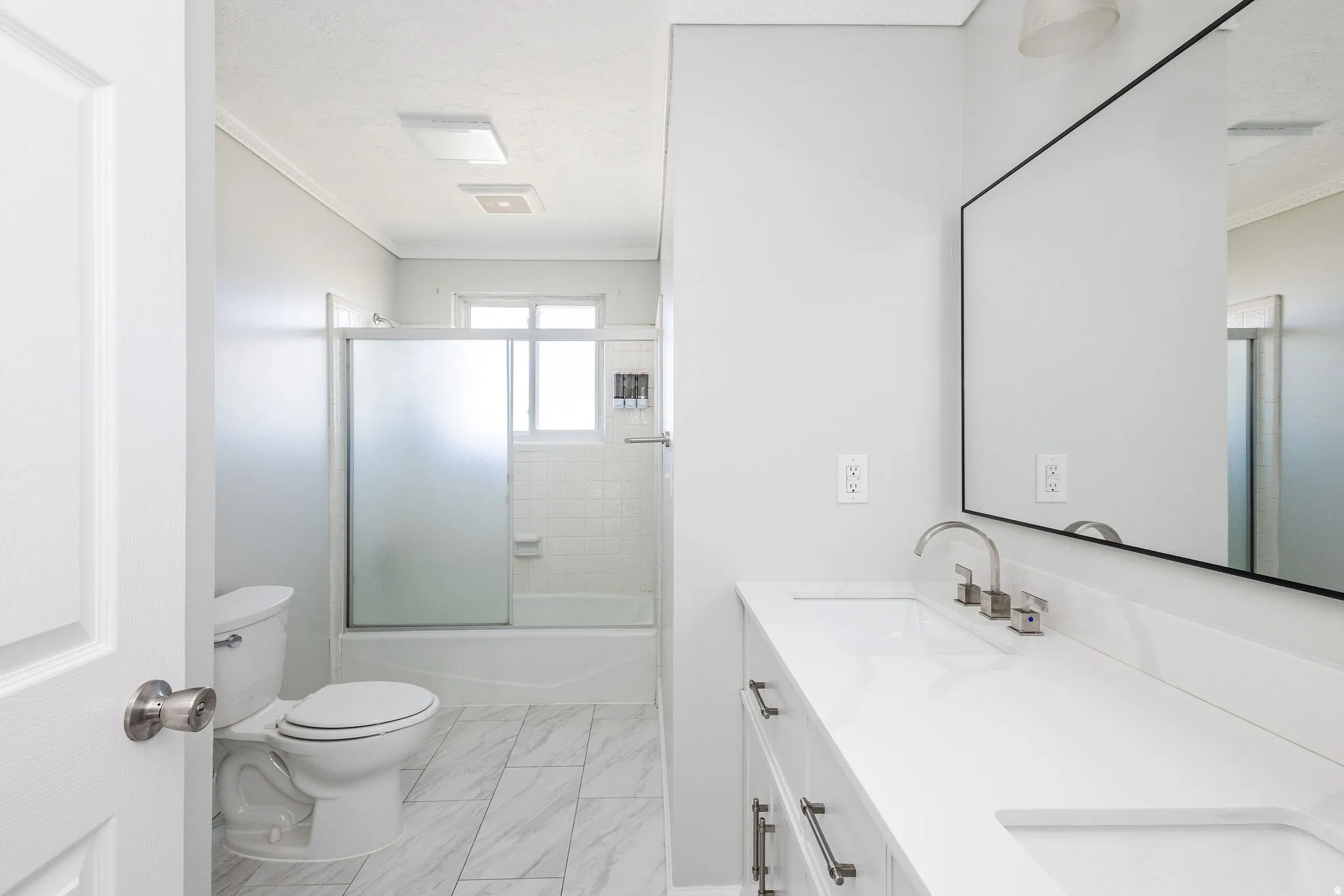 Dual vanity with white countertop and brushed nickel fixtures