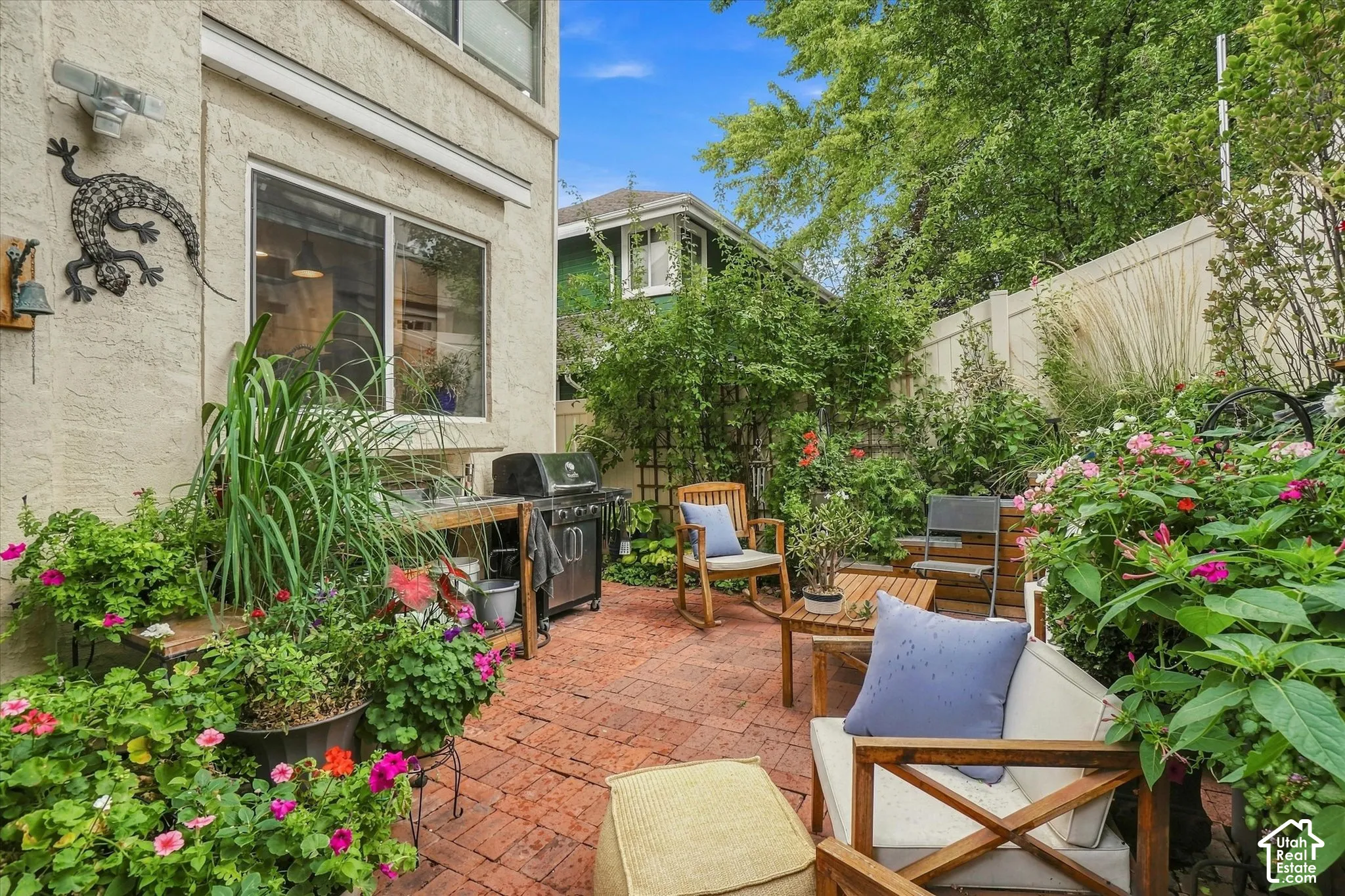 Backyard oasis with brick paver patio with privacy fencing