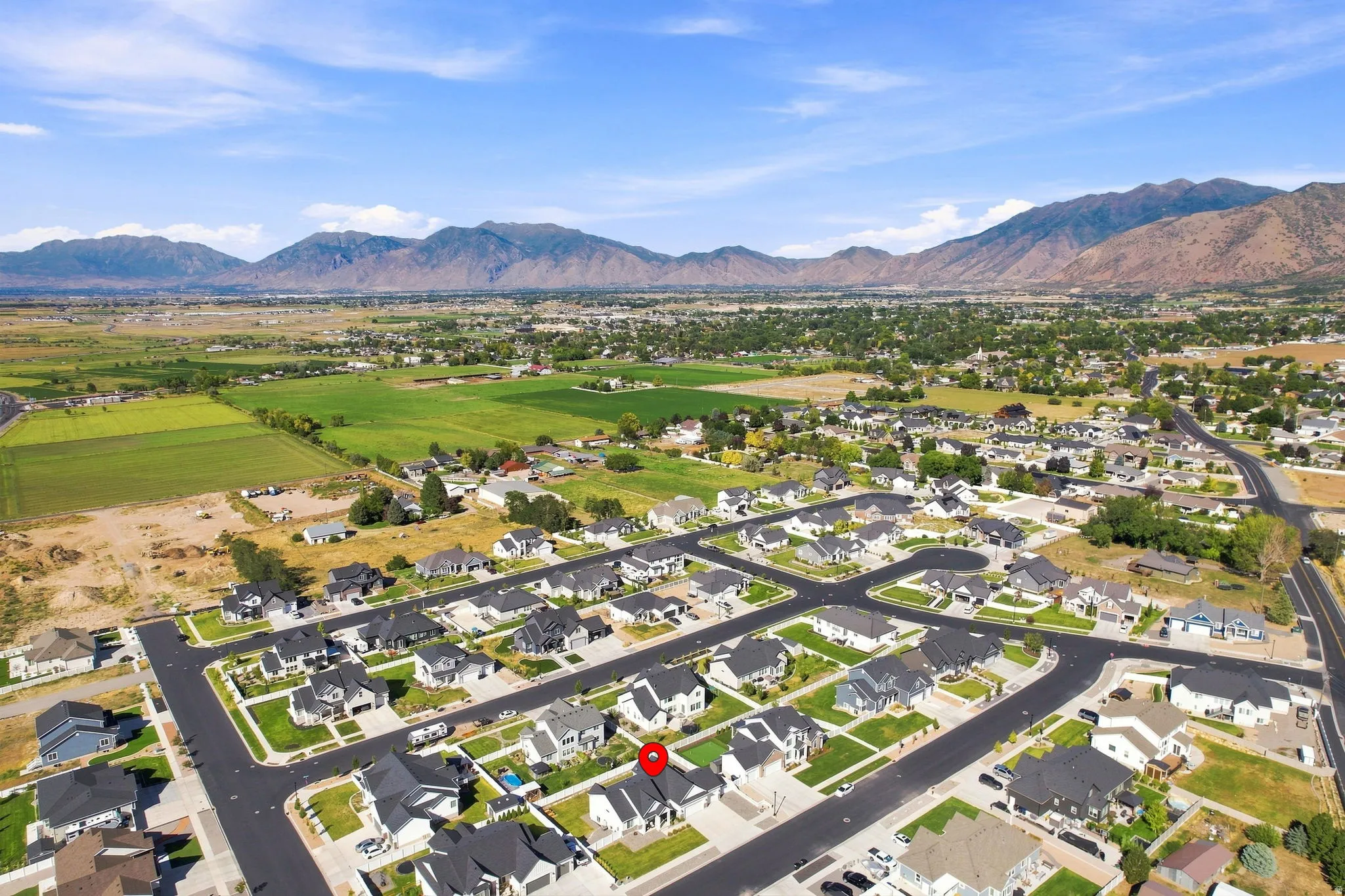 Aerial neighborhood perspective with mountain backdrop and residential streets