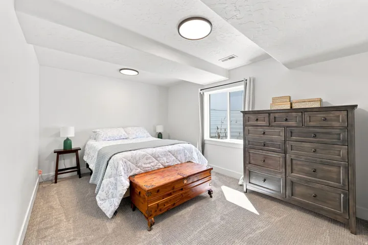 Window with white trim, light-toned carpeting, and recessed lighting fixtures