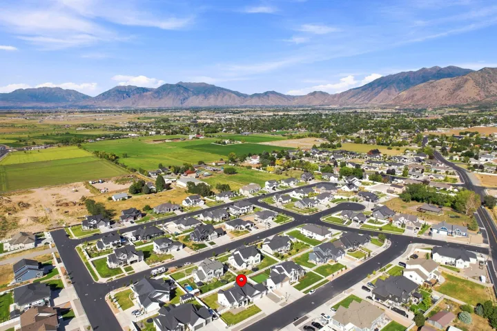 Aerial neighborhood perspective with mountain backdrop and residential streets